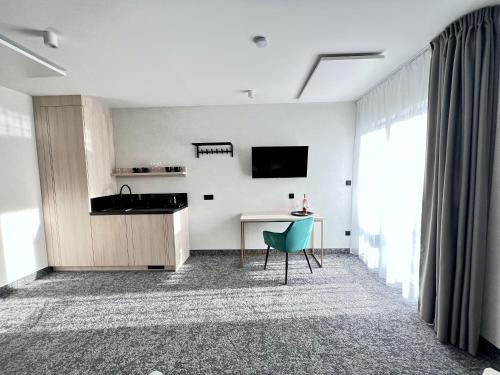 a kitchen and dining room with a table and a chair at SILVER BALTIC in Kołobrzeg