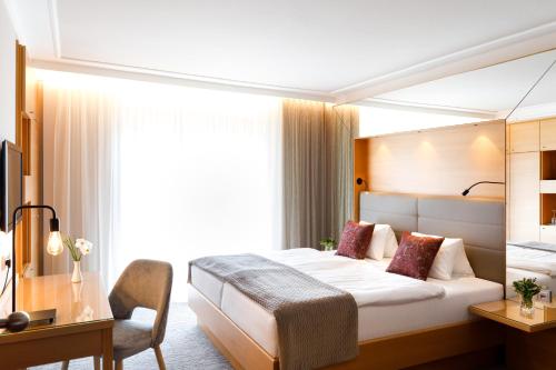 a hotel room with a bed and a desk at Weinlandhof in Gamlitz