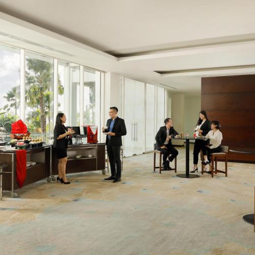 a group of people standing in a room at Resinda Hotel Karawang in Karawang