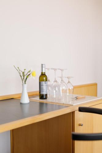 a bottle of wine sitting on a counter with wine glasses at Weinlandhof in Gamlitz