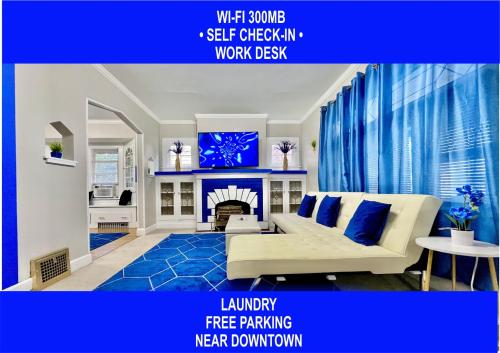 a living room with a white couch and a fireplace at The Sapphire Haven - Your Old Brooklyn Oasis Awaits Families, Couples, Business Travelers Near Downtown With Parking, 300 MB WiFi & Self Check-In in Cleveland