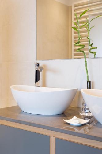 a bathroom with a white bowl sink on a counter at Weinlandhof in Gamlitz