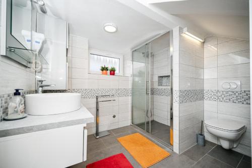a bathroom with a sink and a toilet and a shower at Seafront Apartment Ičići in Ičići