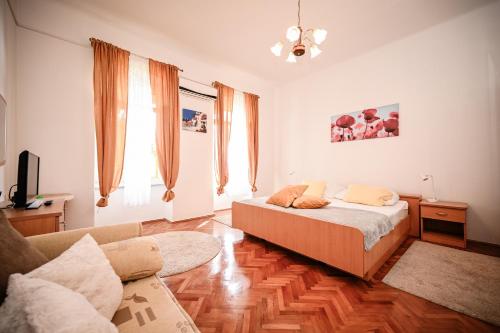 a living room with a bed and a couch at Seafront Apartment Ičići in Ičići