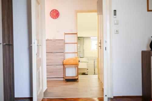 a hallway with a room with a desk and a clock at Seafront Apartment Ičići in Ičići