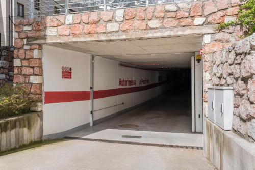 a tunnel leading into a building with a brick wall at Casa Batistei Ribes in Molveno