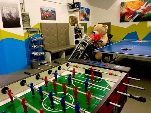 a teddy bear standing next to a ping pong table at Hotel Alfieri in Sirmione