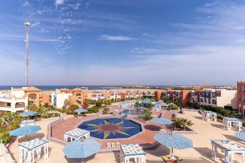 a view of a resort with a pool and tables and umbrellas at Faraana Heights Aqua Park in Sharm El Sheikh