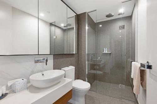 a bathroom with a toilet and a sink and a shower at Parque on St Kilda - 02532 in Melbourne