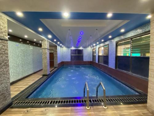 a large swimming pool in a hotel room at Dayal International - New Digha in Digha