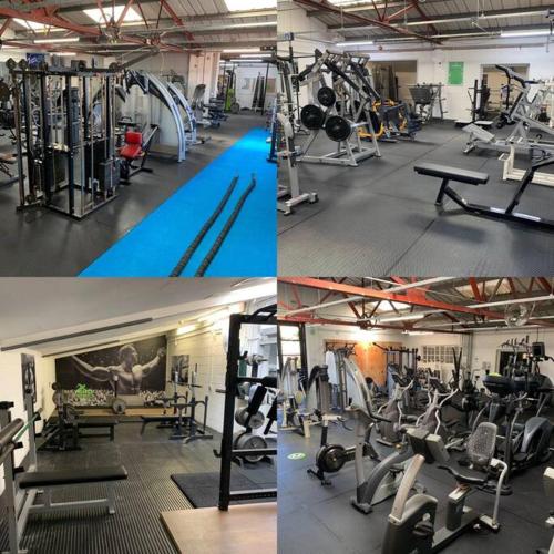 a gym with several different types of machines in it at Beautiful 2 Bed Apartment just steps to the Beach in Weymouth