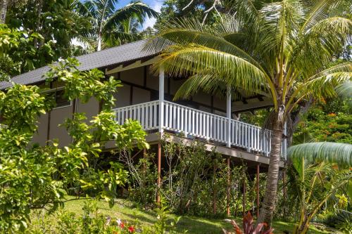 a house with a balcony in the middle of a garden at Iririki Island Resort & Spa in Port Vila