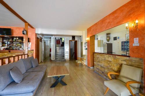 a living room with a couch and a bar at Hotel Orpheus in Gouvia