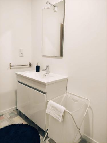 a white bathroom with a sink and a mirror at Casa da Quinta T1 in Mafra