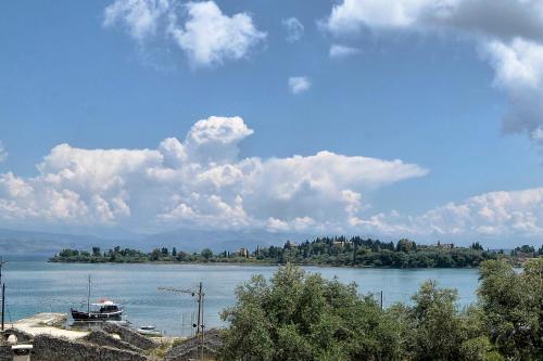 a boat on a river with clouds in the sky at Hotel Orpheus in Gouvia