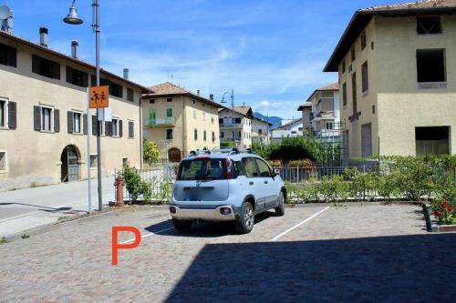 a small car is parked in a parking lot at Casa del Tempo Elsa Tassullo Ospitar in Tassullo