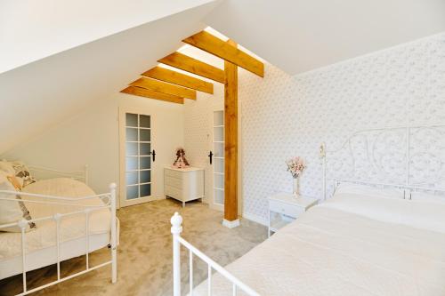 a bedroom with a white bed in a room at Nolcken Lagerhaus in Kuressaare