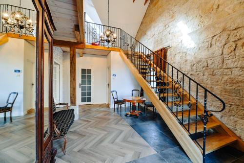 a staircase in a room with a stone wall at Nolcken Lagerhaus in Kuressaare