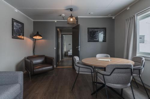 a living room with a table and chairs at Coal Miners’ Cabins in Longyearbyen