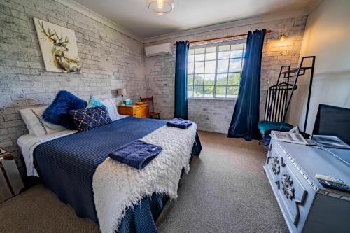 a bedroom with a bed and a television in it at Angel Sussurri in Yarramalong