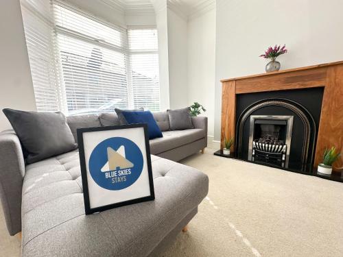 a living room with a couch and a fireplace at Wrightson House by Blue Skies Stays in Stockton-on-Tees