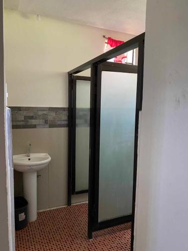 a bathroom with a toilet and a sink and a mirror at Reel Place in Kayagan