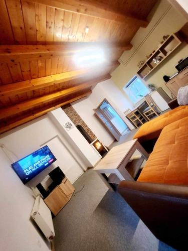 vista sul soffitto di un soggiorno con divano e TV di Apartmán Denny a Kežmarok