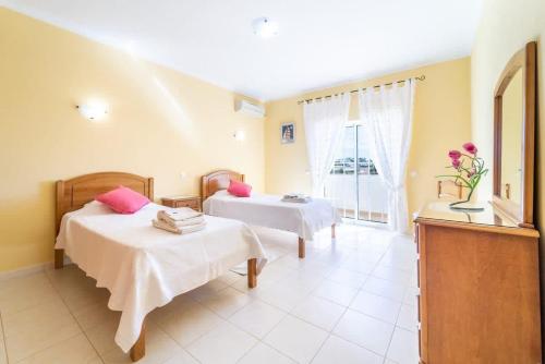 a hotel room with two beds and a window at Villa Mina - Large house sleeps 9, walk to beach, golf and shops in Guia