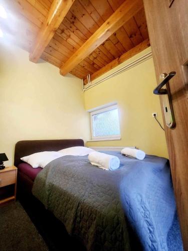 a bedroom with a bed with two towels on it at Apartmán Denny in Kežmarok