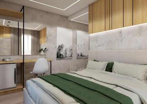1 dormitorio con 1 cama grande con manta verde en Arel Hotel, en Sarandë