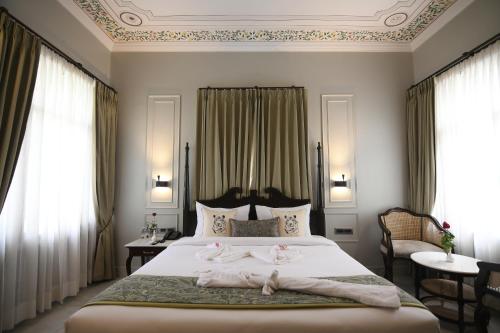 1 dormitorio con 1 cama con toallas en The Tiger Villa by ATD India - Group of Hotels and Resorts, en Sawāi Mādhopur