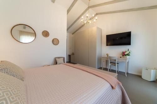 a bedroom with a bed and a table and a mirror at Le Casette di Giò in Monteodorisio