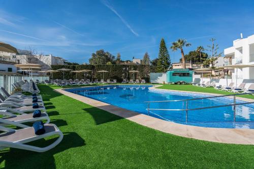 a swimming pool with lounge chairs and a resort at THB Maria Isabel - Adults Only in Playa de Palma