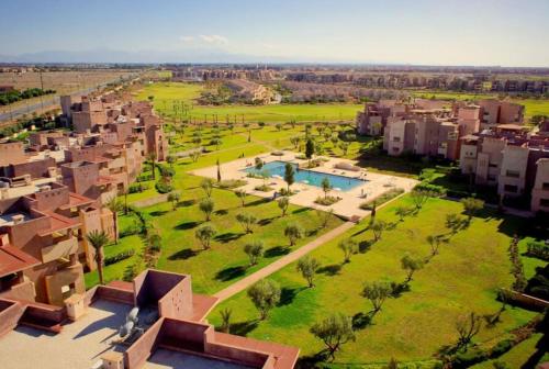 an aerial view of a city with buildings and a park at Luxurious appartement in Marrakech with Pool&Golf PRESTIGIA AMBRE in Marrakesh