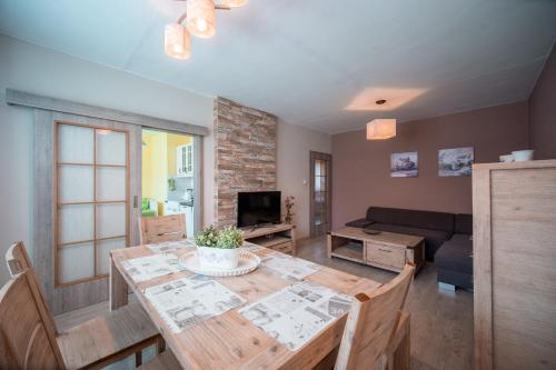 a living room with a table and a couch at Apartmán Loučná nad Desnou in Loučná nad Desnou