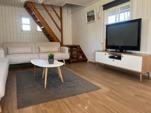 a living room with a couch and a tv at Joosepi Holiday House in Silla