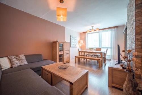 a living room with a couch and a table at Apartmán Loučná nad Desnou in Loučná nad Desnou