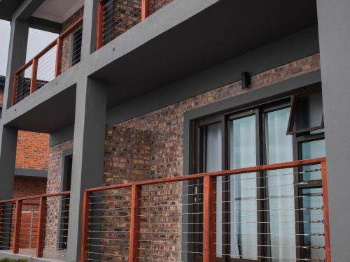 a facade of a building with a balcony at White Sands Self-catering units in Wilderness