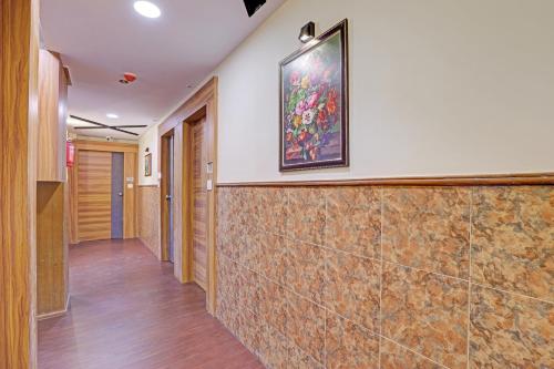 a hallway of a hospital with a painting on the wall at OYO Flagship Hotel Swagat Inn in Ahmedabad