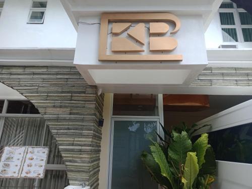 a sign that reads k on the front of a building at bucana traveler's inn in Guinisiliban