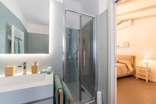 a bathroom with a glass shower in a room at Le Casette di Giò in Monteodorisio
