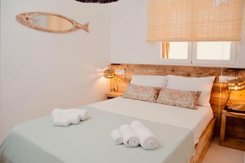 a bedroom with two white towels on a bed at Can Sorra - Modern & Stylish Villa in Sant Ferran de Ses Roques