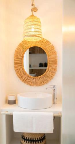 a bathroom with a sink and a mirror at Can Sorra - Modern & Stylish Villa in San Ferrán de ses Roques