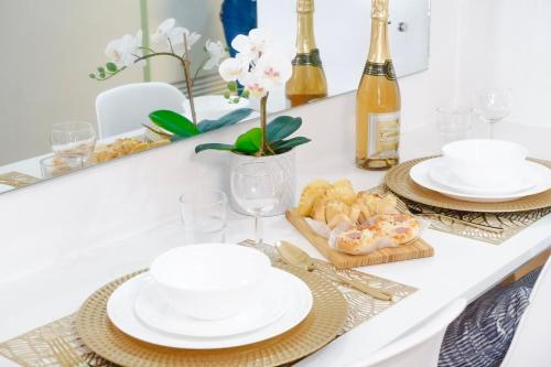 a white table with plates and dishes on it at Ezren Suites Mesavirre Residences Unit922 in Bacolod