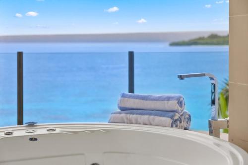 a group of towels sitting on the edge of a bath tub at Iririki Island Resort & Spa in Port Vila