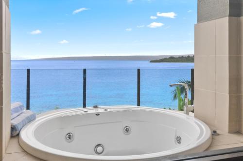 a bath tub with a view of the ocean at Iririki Island Resort & Spa in Port Vila