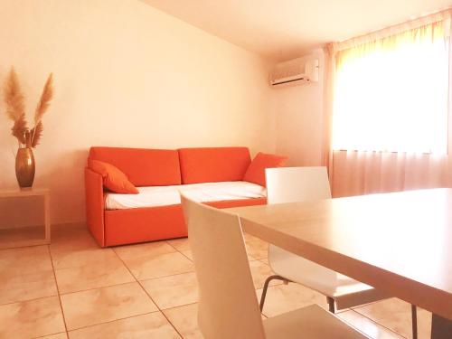 a living room with a couch and a table at Hotel Park in Rossano