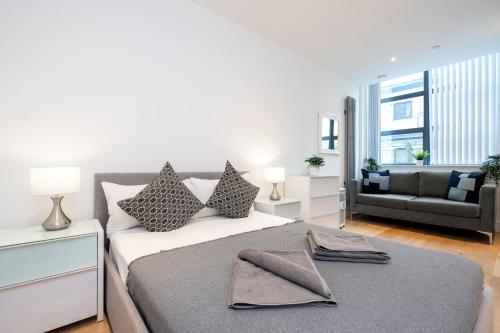 a bedroom with a bed and a living room at Camden Town Apartments in London