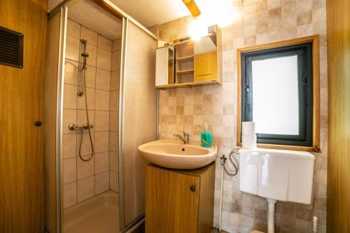 a bathroom with a sink and a shower at Domki Letniskowe in Nielisz