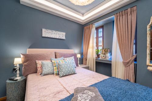 a bedroom with a bed with pillows on it at Dandy Villas Nymfaio - Snow Queen - Sauna - Fireplace - Up to 6 adults 2kids in Nimfaíon